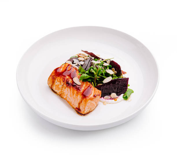 istock Deliciously plated salmon with greens and beets presented elegantly on a white dish 2197564078