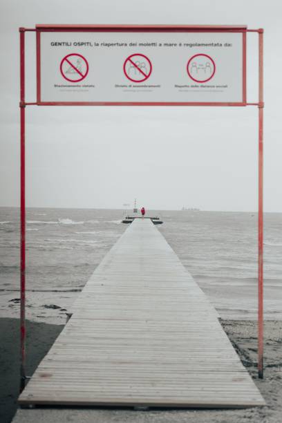 istock Solitary figure on stormy pier 2197565836