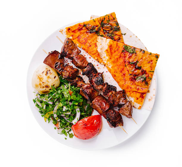 istock Delicious grilled skewers served with flatbread and fresh vegetables in a vibrant setting 2197566274
