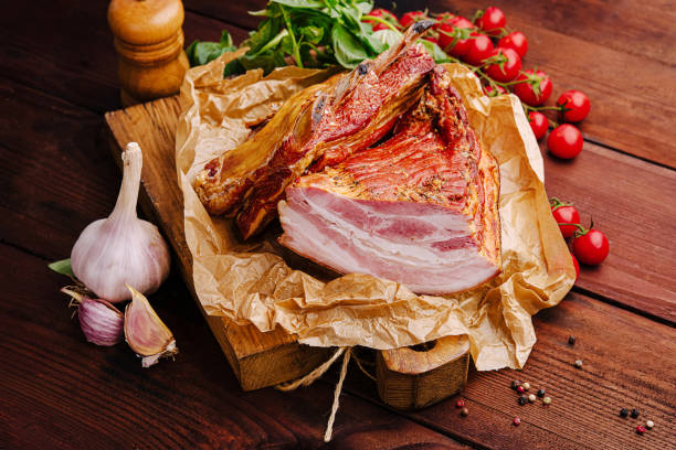 istock Freshly sliced meat with garlic and cherry tomatoes on a wooden table 2197567371