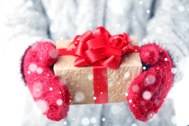 istock Female hands holding gift box with ribbon 2197569932