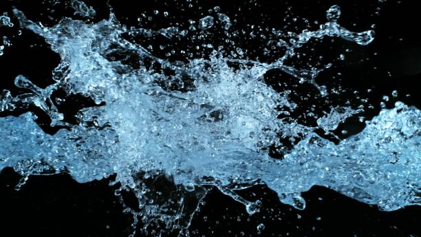istock Water Splashes Flying in the Air on Black Background 2197570789