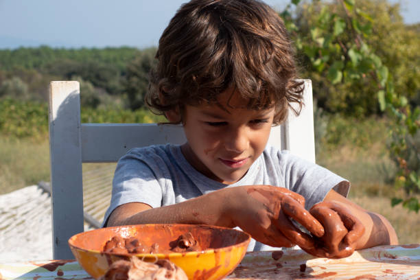 Muddy, messy child playing outside