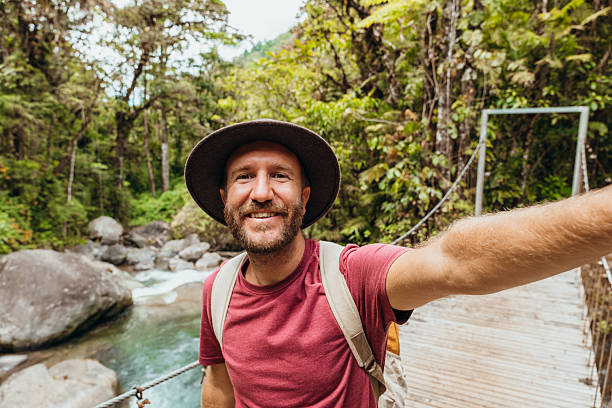istock Man Taking Selfie on Scenic Jungle Bridge 2197575159
