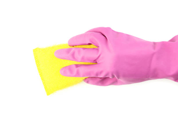 istock Female hand holding cleaning sponge on white background 2197576336