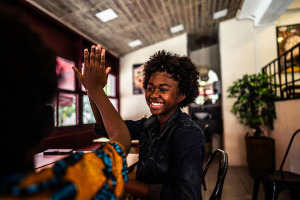 istock Siblings high fiving in a restaurant 2197576443