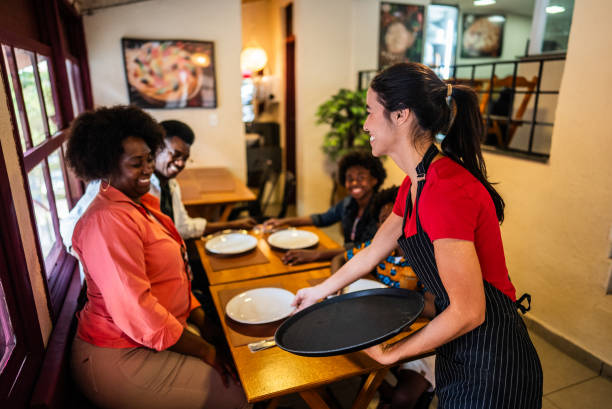 istock Waitress serving customers in a restaurant 2197576526