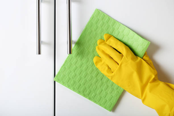 istock Hand in glove cleaning kitchen cabinet 2197576556