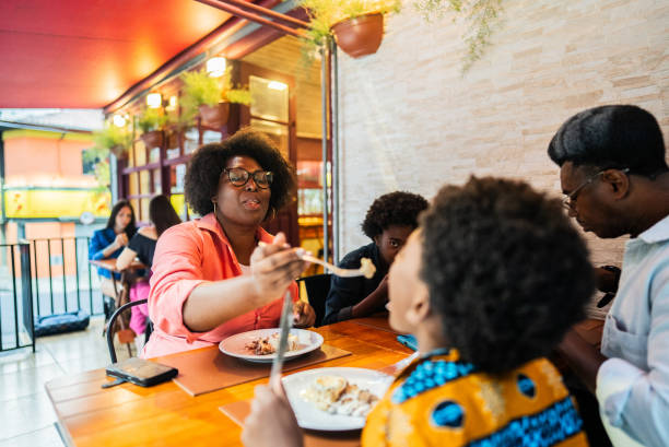 istock Mother feeding her son in a pizzeria 2197576612