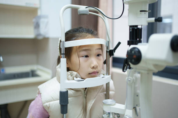 istock Asian little girl having her eyesight tested 2197576943
