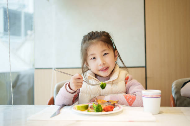 istock Asian children eating 2197577030
