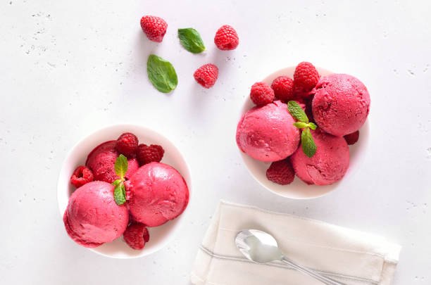 istock Raspberry ice cream scoop with fresh raspberries in bowl and fresh raspberries 2197578978