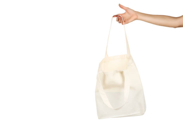 istock Female hand holding white cotton eco bag on white background 2197582493