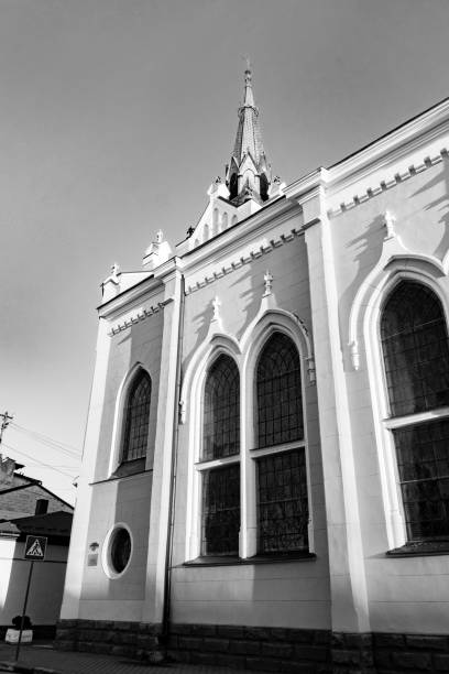 A black and white image showcasing the neo-Gothic architectural elements of a grand public building, highlighting its intricate design.