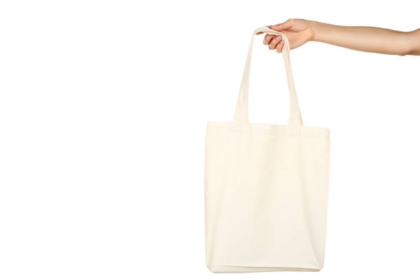 istock Female hand holding white cotton eco bag on white background 2197582806