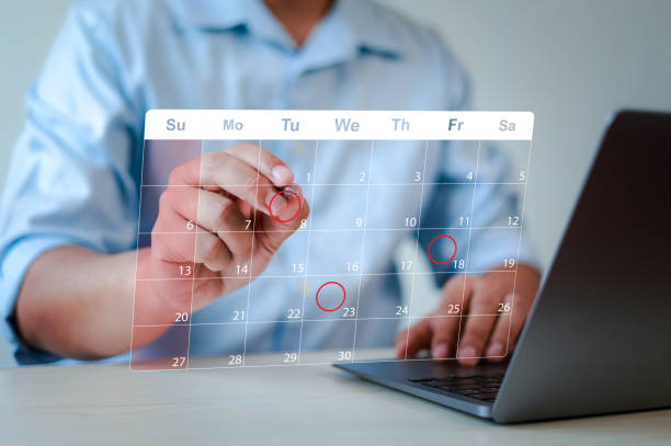 istock Business planning calendar concept, work schedule, businessman using pen to write on calendar on virtual screen and organize schedule and important dates, meeting time management. 2197583490