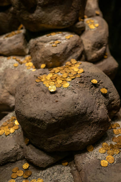 istock Ancient Colonial Gold Coins on Large Stones Found Treasure 2197583970