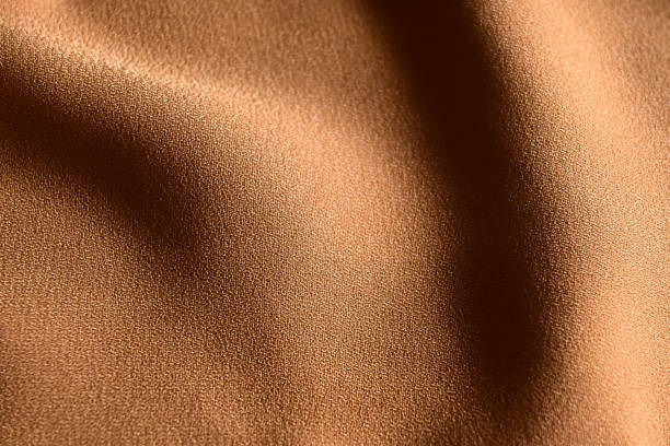 istock golden wollycrepe fabric as the background. 2197584982