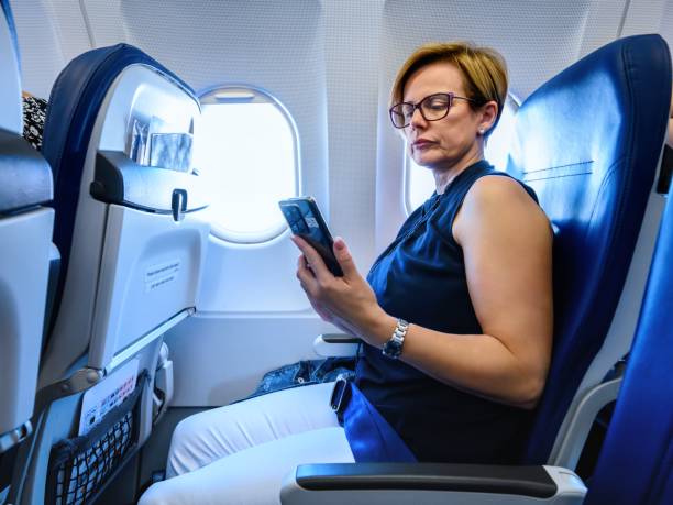istock Business woman at airplane 2197585077