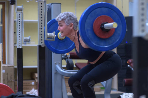 istock A senior weightlifter in profile lifting her dumbbells 2197585246