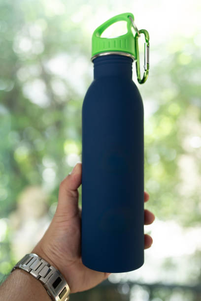 istock Male hand holding blue reusable steel bottle 2197586630