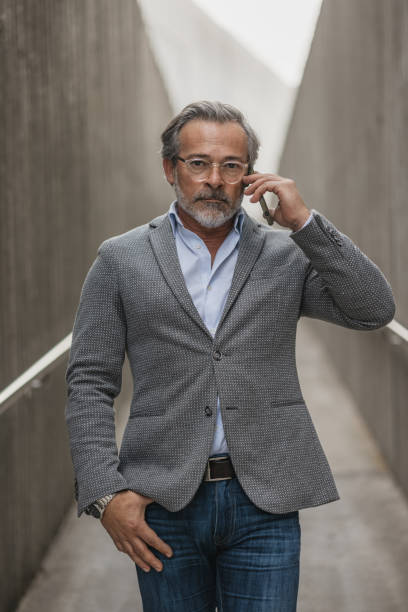 istock Stylish Man Speaking on Phone in Modern Setting 2197587188