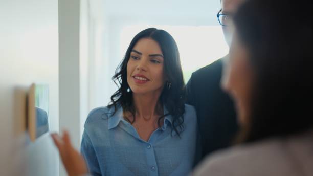 istock Real Estate Agent Demonstrating Smart Home Features 2197587989