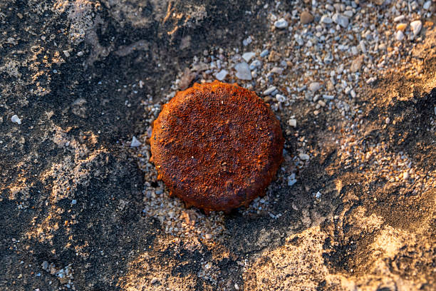 Top view of inner side of glass bottle soda metal caps designed on white surface,background