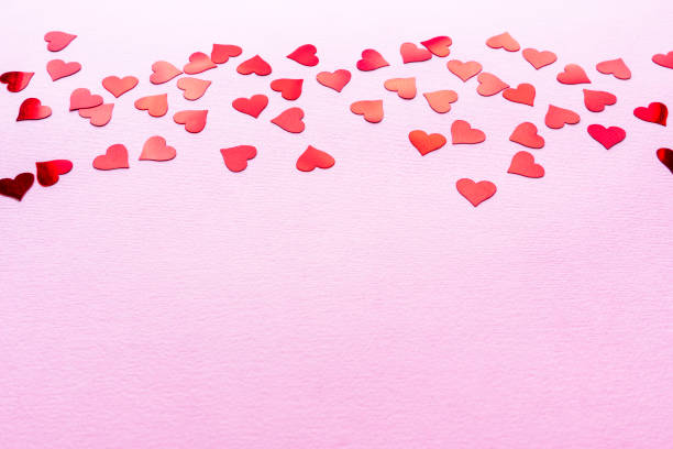 istock Valentines postcard background. Stylish red hearts confetti frame on pink background with copy space. Happy valentines day. Love banner 2197589710