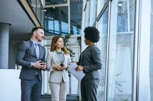 istock Team of professionals in an office discussion 2197595107