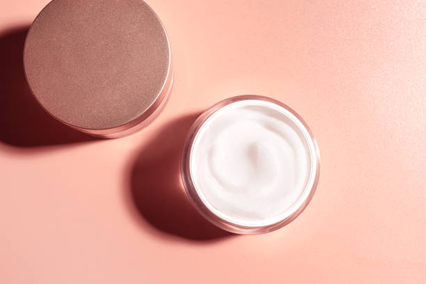istock Cosmetic cream jar on pink beige background 2197595262
