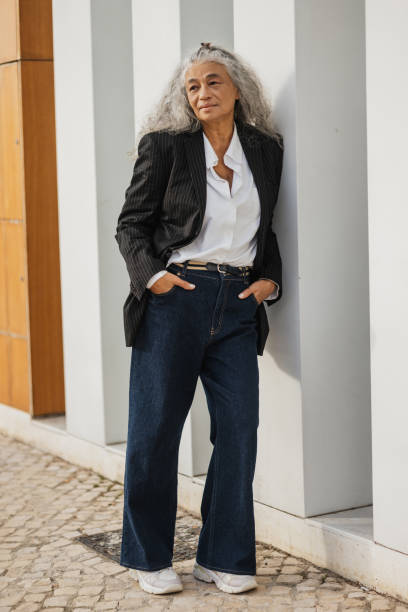 istock Stylish Woman Posing Against Modern Architecture 2197595337