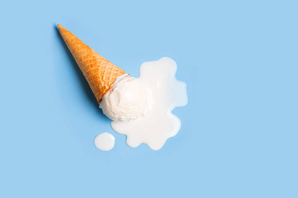 istock White ice cream melting and spilling from waffle cone 2197595814