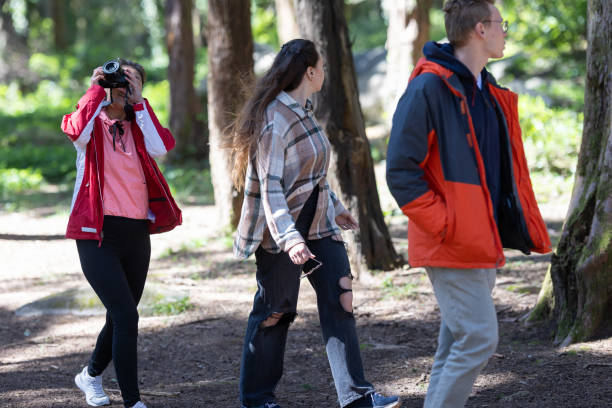 istock Group of young friends Walking Through a Forest 2197595994