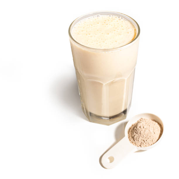 istock Glass with protein shake and powder in scoop 2197596166