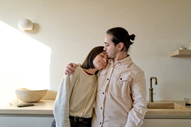 istock Young couple sharing an intimate moment in modern kitchen 2197597420