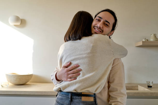 istock Happy couple embracing in cozy kitchen setting 2197597561