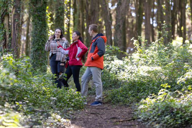 istock Group of People Walking Through a Forest 2197598019