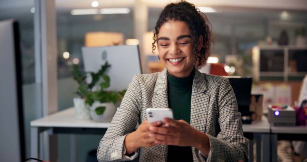 istock Smile, phone and typing with business woman in office for overtime, client communication and research. Happy, networking and feedback with person and mobile at night for connection and online 2197601310
