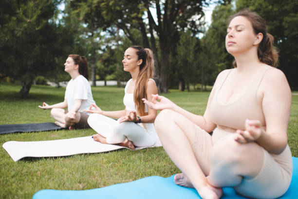 istock Group of girls doing yoga 2197601554