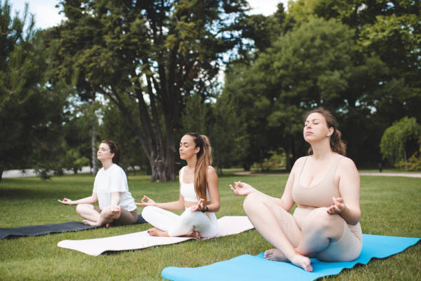 istock Group of girls doing yoga 2197601745