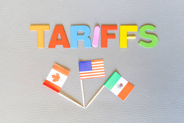 U.S. trade policy. Tariffs forgiven to Canada and Mexico. Word (TARIFFS) and flags. Copy space on textured background. Horizontal photo. Trump game