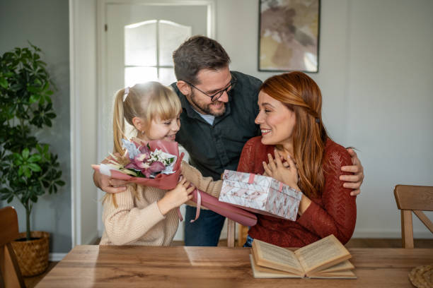 istock Mother's Day surprise with flowers and a gift 2197604018