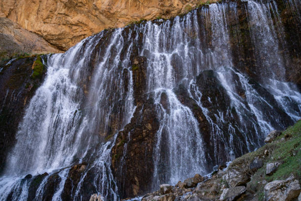 a large waterfall flowing at high velocity. Kapuzbasi waterfall.