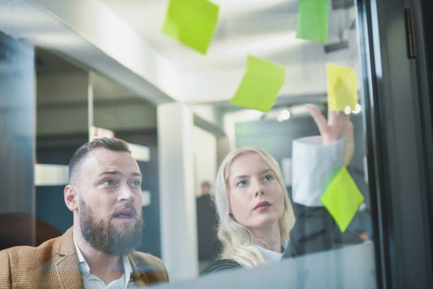 istock Male CEO Reading Notes From Colleagues After Business Meeting Looking Surprised 2197606026