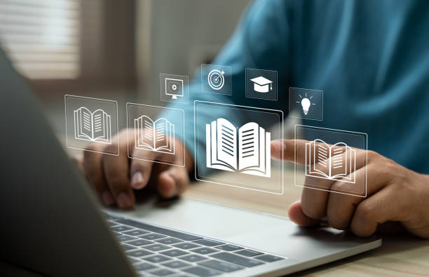 istock E-library and E-learning Concept, Person using laptop with virtual E-Book icons for online knowledge Base, Digital library, Access electronic books on Internet. Course education. Webinar technology. 2197606210