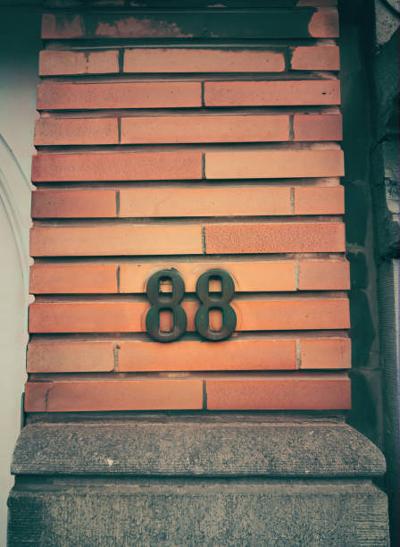 istock House number eighty eight and a textured brick wall. 2197609872