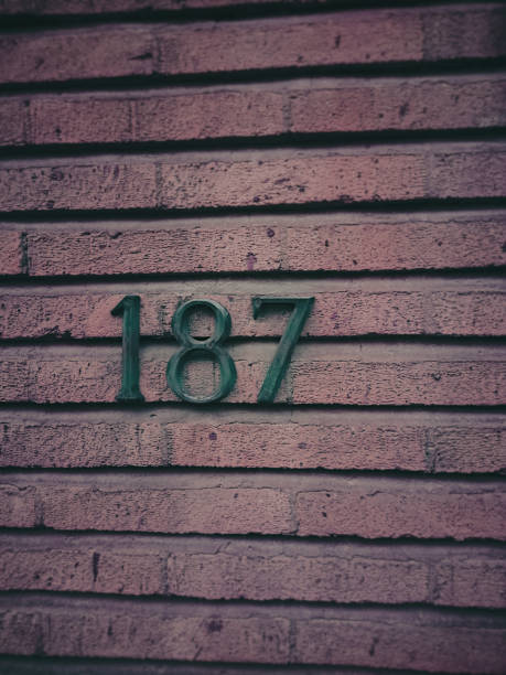istock House number one hundred and eighty seven and a textured brick wall 2197610370