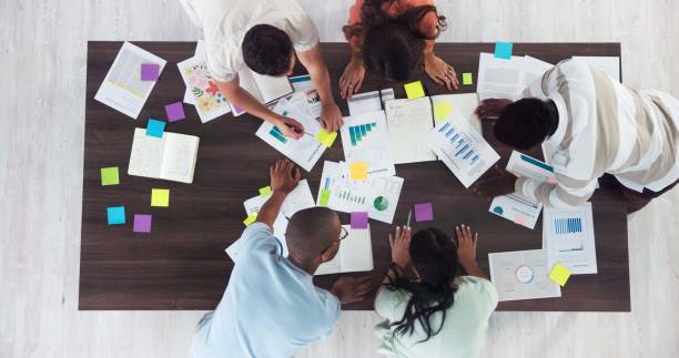 istock Above, workshop and documents with business people in office for event planning, budget and schedule proposal. Project management, teamwork and marketing strategy with employees for campaign producer 2197611709