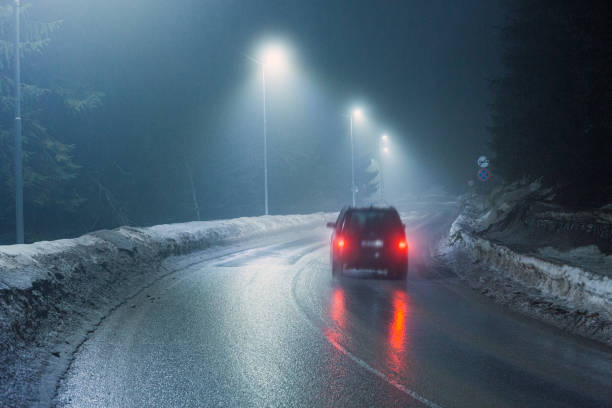 istock Driving in foggy winter night 2197612101